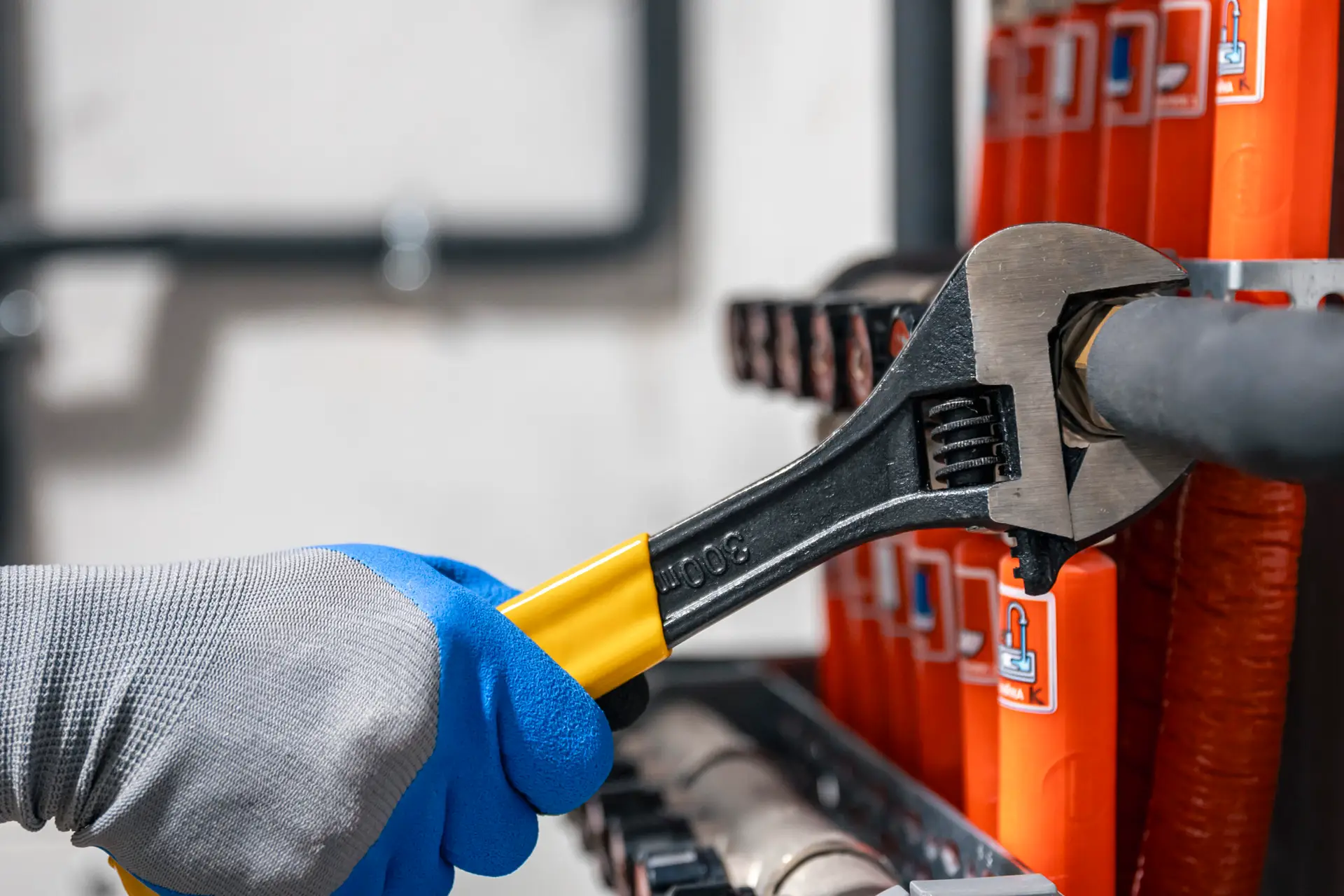 male hands with a wrench turning off valves.